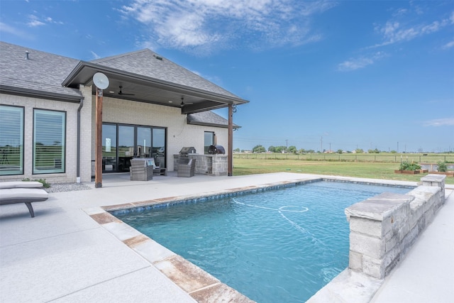 pool featuring a patio area, area for grilling, fence, ceiling fan, and a lawn