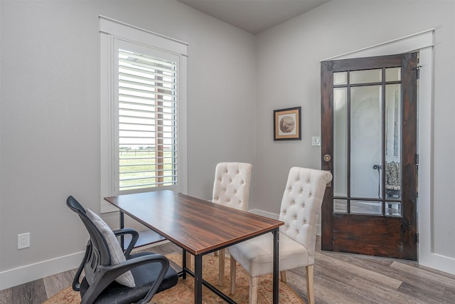 office area featuring light wood finished floors and baseboards