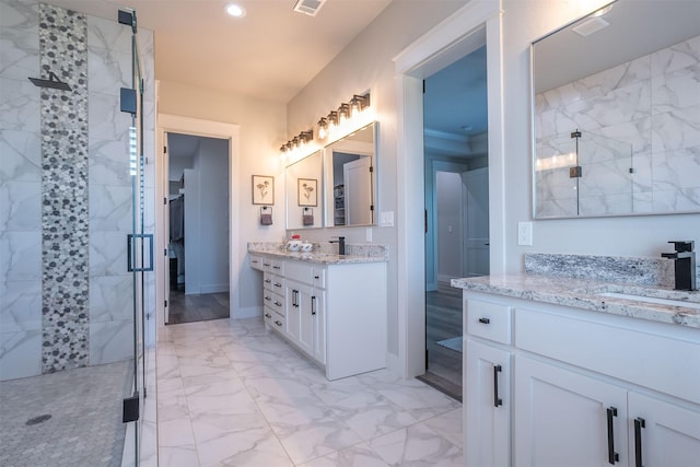 bathroom featuring a stall shower, a sink, two vanities, marble finish floor, and recessed lighting