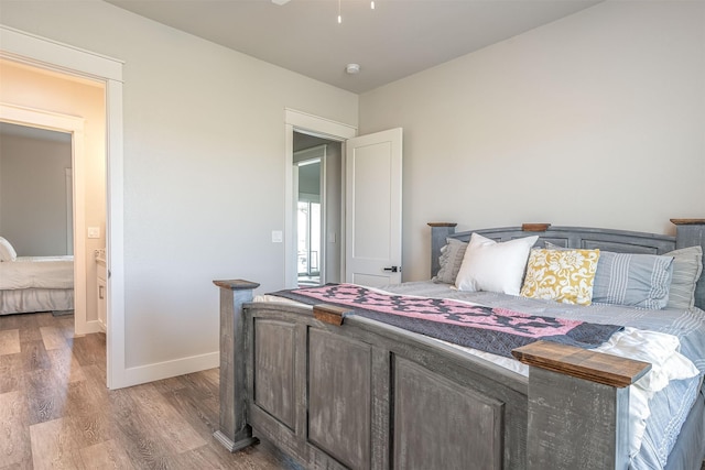 bedroom featuring baseboards and light wood-type flooring