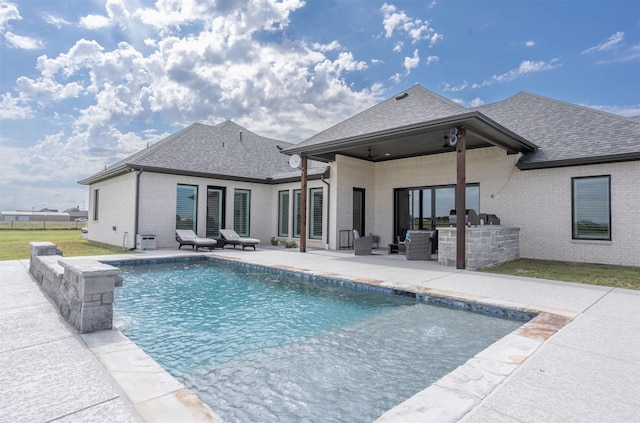 outdoor pool with ceiling fan, a patio, and an outdoor kitchen