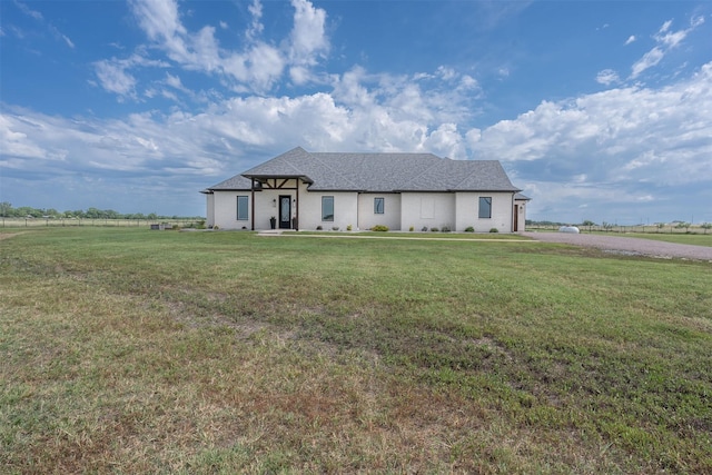 ranch-style home with driveway, roof with shingles, a front lawn, and a garage