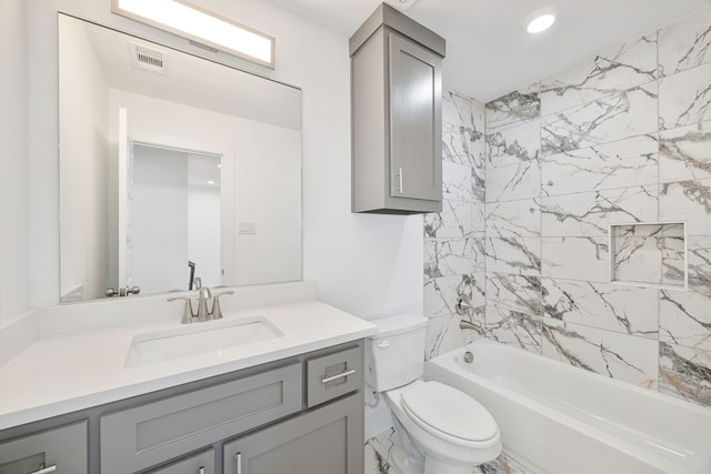 full bathroom featuring toilet, vanity, and tiled shower / bath combo