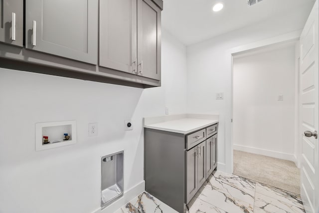 clothes washing area with cabinets, electric dryer hookup, and hookup for a washing machine