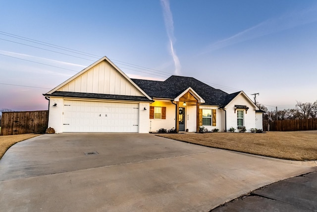 view of front of house with a yard and a garage