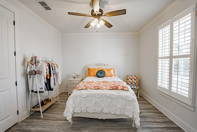 bedroom featuring ornamental molding, dark hardwood / wood-style floors, and ceiling fan