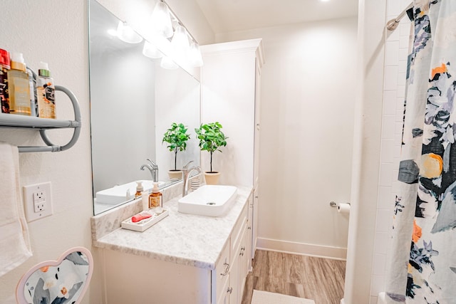 bathroom with vanity and wood-type flooring