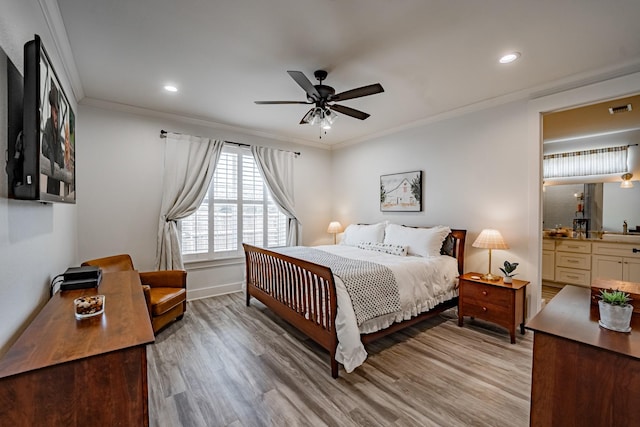 bedroom with connected bathroom, light hardwood / wood-style flooring, ceiling fan, and ornamental molding