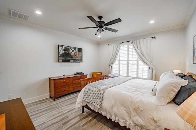 bedroom featuring ceiling fan, ornamental molding, and light wood-type flooring