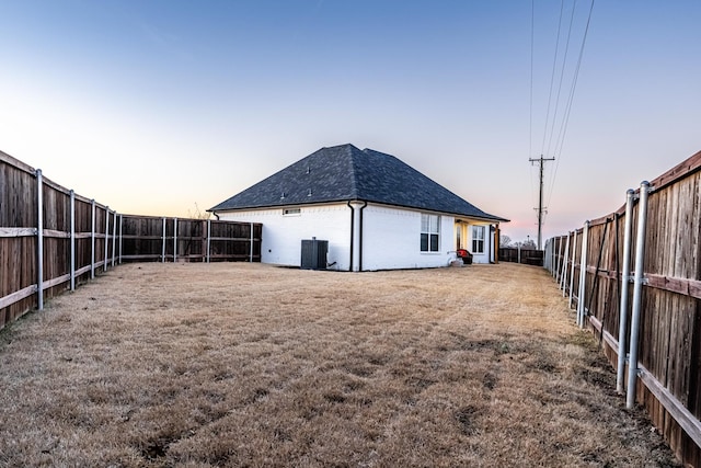 yard at dusk with central AC