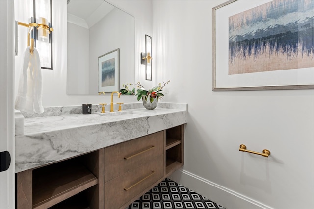 bathroom with crown molding, vanity, and baseboards