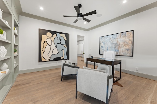 office space featuring a ceiling fan, light wood-type flooring, and baseboards