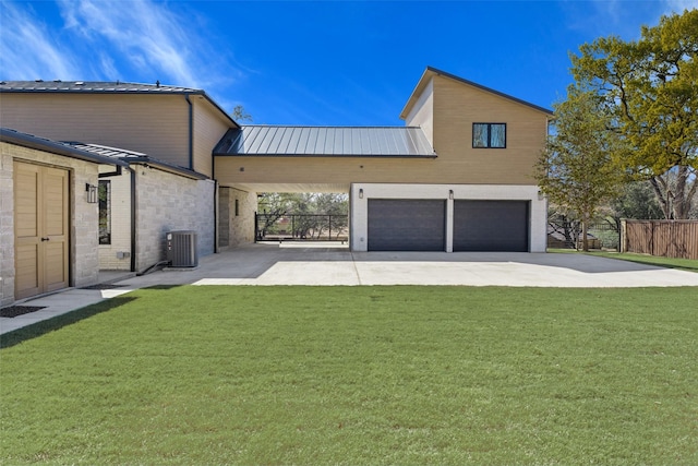 exterior space featuring central AC, fence, and driveway