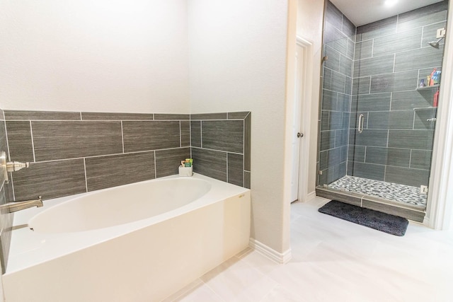 bathroom featuring tile patterned flooring and plus walk in shower