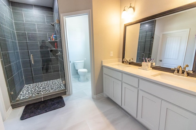 bathroom featuring vanity, tile patterned flooring, toilet, and a shower with shower door