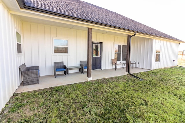 back of property with a patio area and a yard