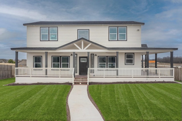 farmhouse featuring covered porch and a front yard