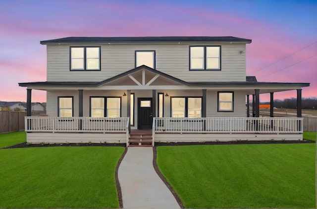 view of front of property featuring a lawn and a porch