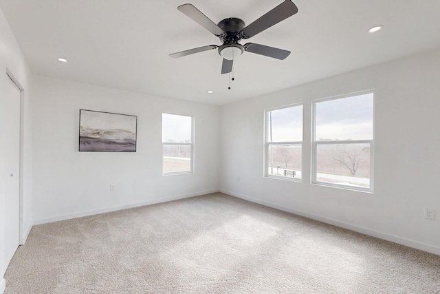 unfurnished room with recessed lighting, baseboards, light colored carpet, and a ceiling fan