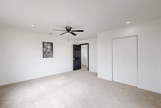 unfurnished bedroom featuring a closet, light carpet, baseboards, ceiling fan, and recessed lighting