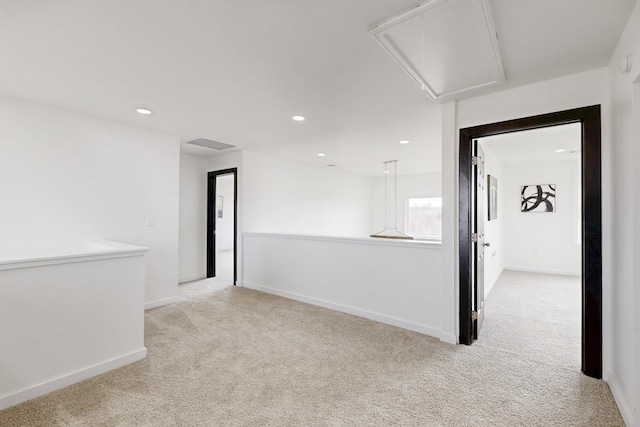 carpeted spare room featuring visible vents, attic access, baseboards, and recessed lighting