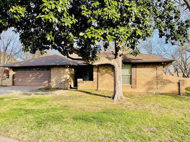 ranch-style house featuring a front lawn and a garage