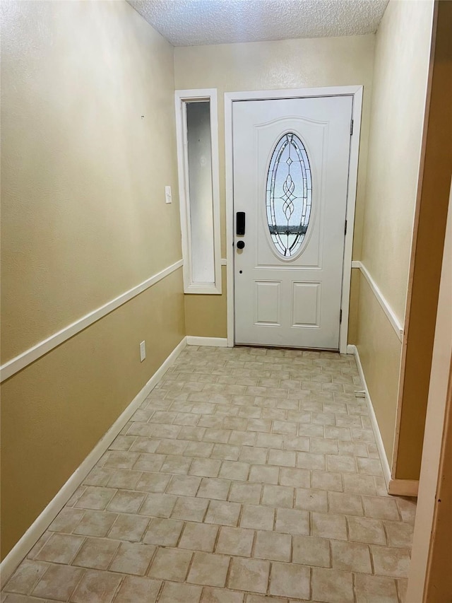 entryway with a textured ceiling