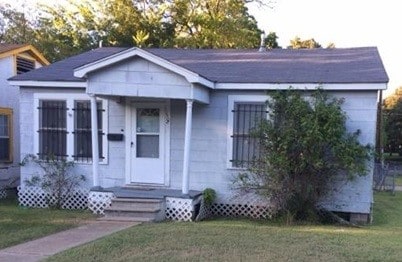 bungalow with a front lawn