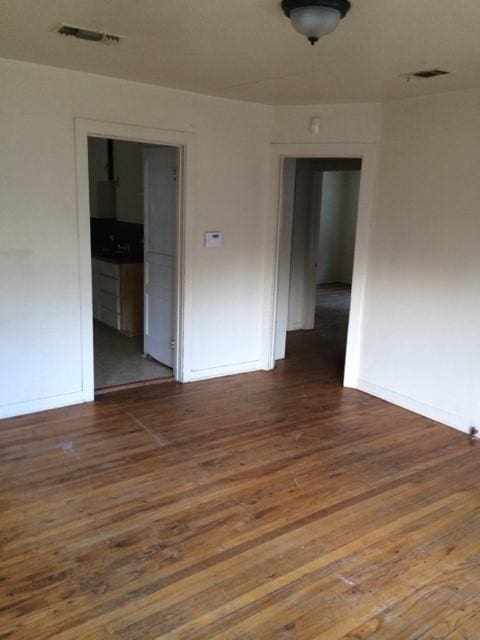 unfurnished room featuring dark wood-type flooring