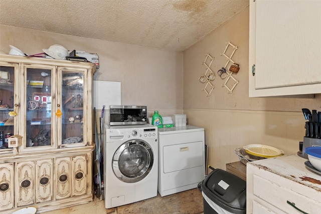 washroom featuring washer and clothes dryer and a textured ceiling