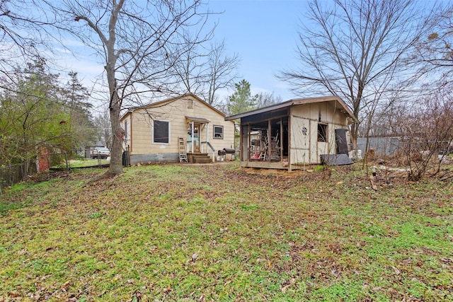 back of property featuring an outbuilding