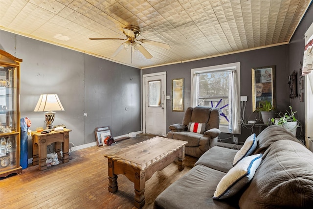 living room featuring ceiling fan, crown molding, and light hardwood / wood-style floors