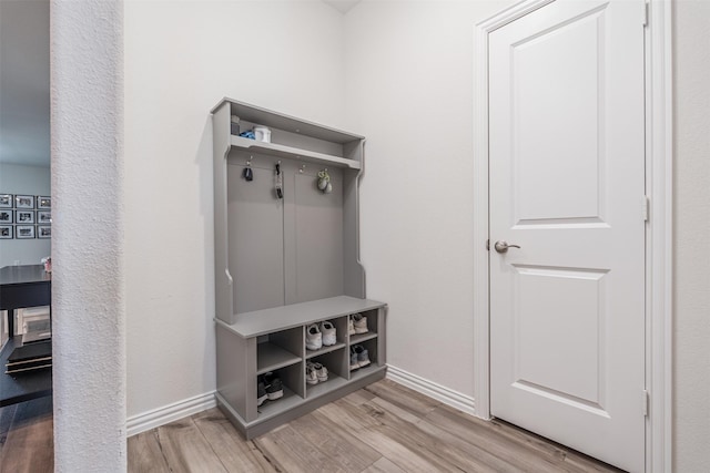 mudroom with light wood-style flooring and baseboards