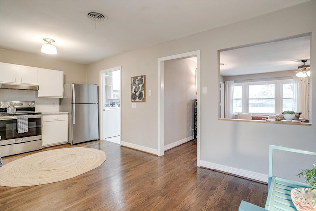 kitchen with stainless steel appliances, backsplash, ceiling fan, dark wood-type flooring, and white cabinets