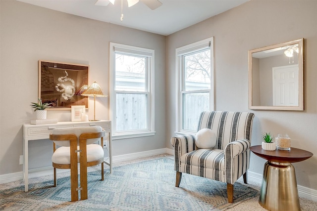 sitting room featuring ceiling fan