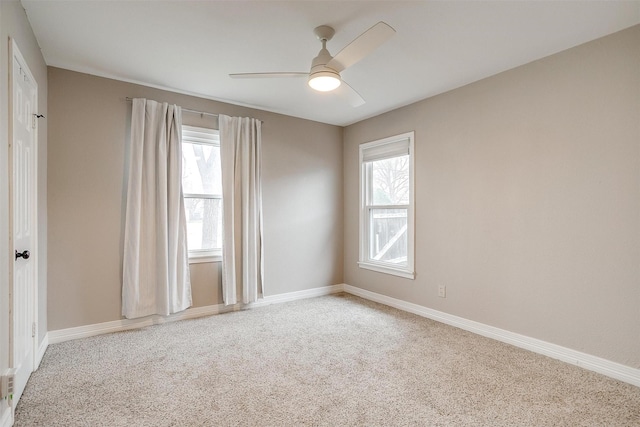 carpeted empty room featuring ceiling fan