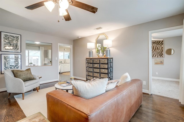 living room featuring ceiling fan, sink, and wood-type flooring