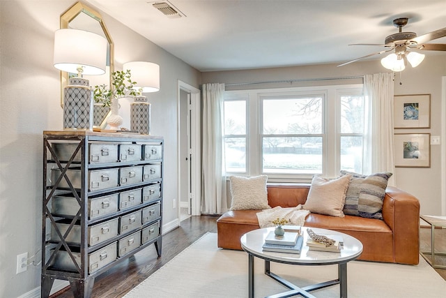 sitting room with hardwood / wood-style flooring and ceiling fan