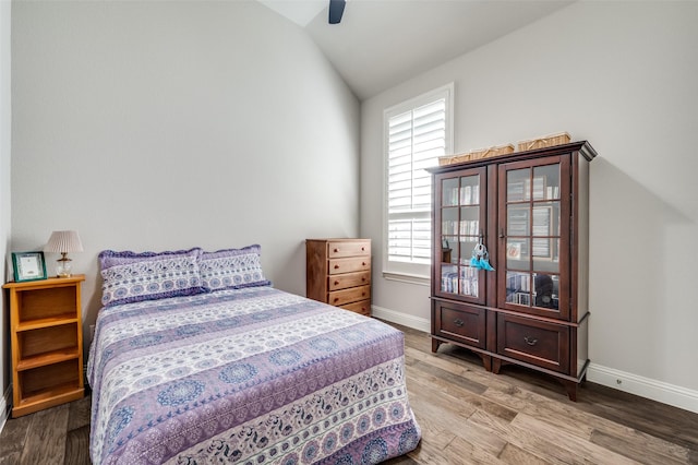 bedroom with hardwood / wood-style floors, lofted ceiling, and ceiling fan