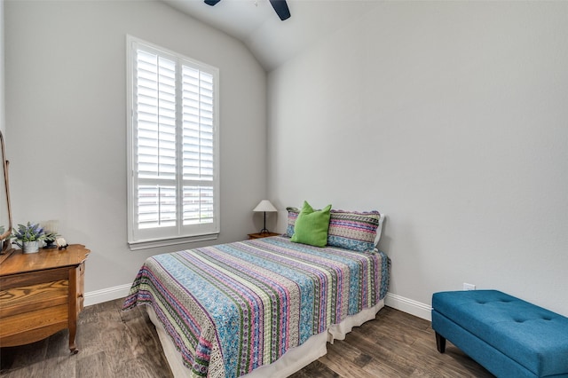 bedroom with dark wood-type flooring, vaulted ceiling, and ceiling fan