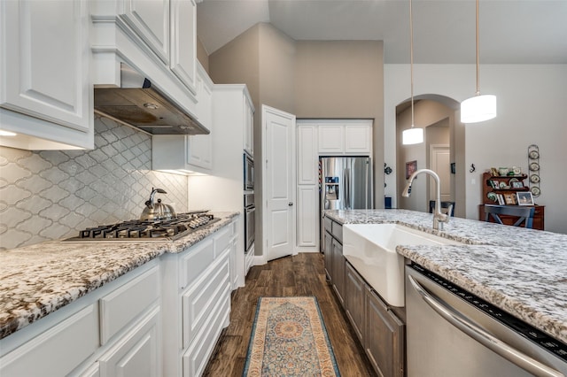 kitchen with sink, stainless steel appliances, dark hardwood / wood-style flooring, white cabinets, and hanging light fixtures