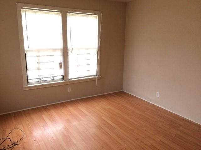 unfurnished room with light hardwood / wood-style floors