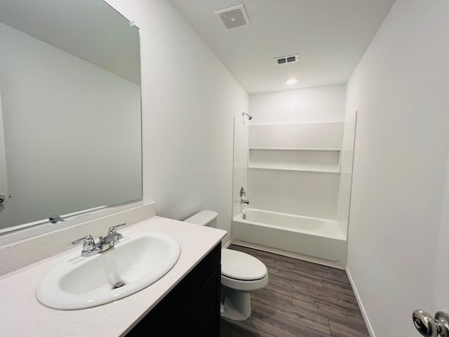 full bathroom with wood-type flooring, vanity, toilet, and tub / shower combination