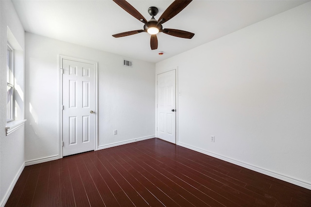 empty room featuring ceiling fan and dark wood-type flooring