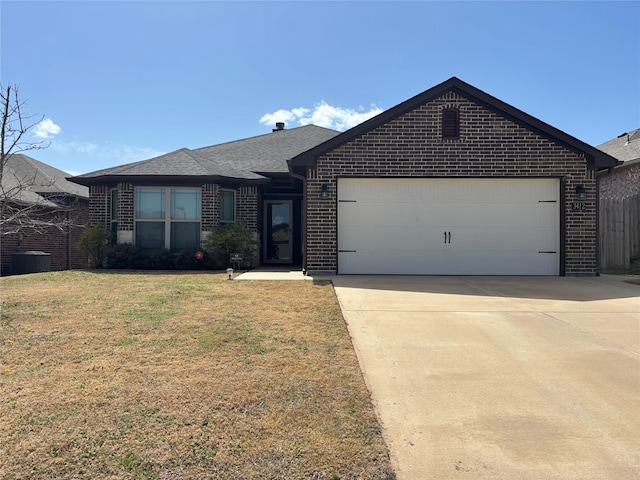 ranch-style home featuring roof with shingles, concrete driveway, a front yard, an attached garage, and brick siding