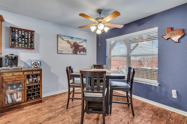 dining room with hardwood / wood-style flooring and ceiling fan