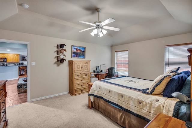 carpeted bedroom with vaulted ceiling and ceiling fan