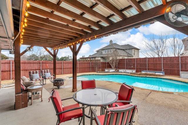 view of pool with a patio and an outdoor fire pit