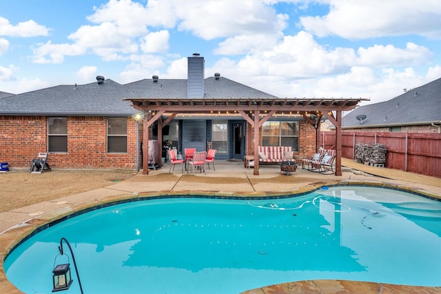 view of pool with a patio and a fire pit