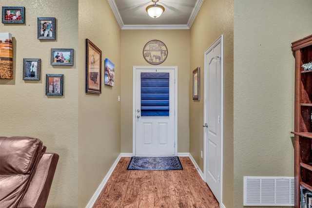 entryway featuring crown molding and hardwood / wood-style floors